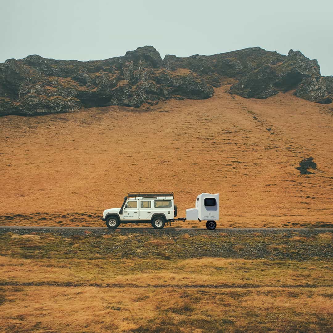 Trailer being towed in rugged mountain landscape